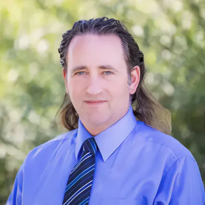 Headshot of Paul Harmsen with nature background