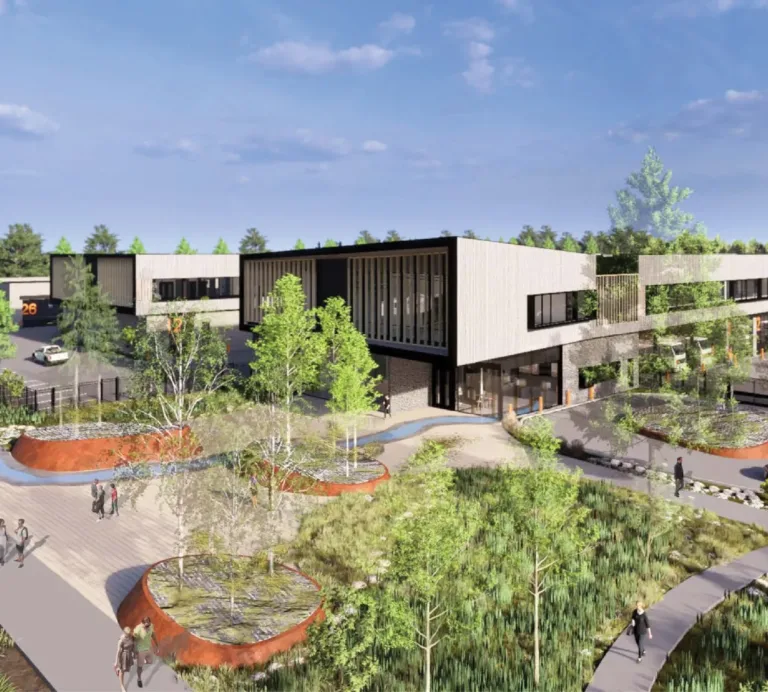 Architectural rendering of a modern two‑story commercial campus with long rectangular buildings, large windows, parking areas, and landscaped pedestrian paths with trees and raised planters under a blue sky.
