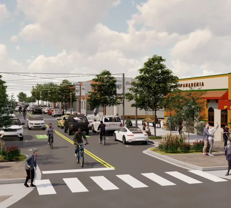 Rendering of a lively, tree-lined commercial street with cars sharing the road with cyclists, pedestrians using a striped crosswalk, string lights overhead, and outdoor seating by a panadería.