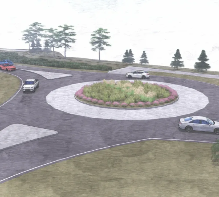 Architectural rendering of a single-lane roundabout with a landscaped central island of grasses and pink flowers, several cars navigating the circle, and trees bordering the roadway.