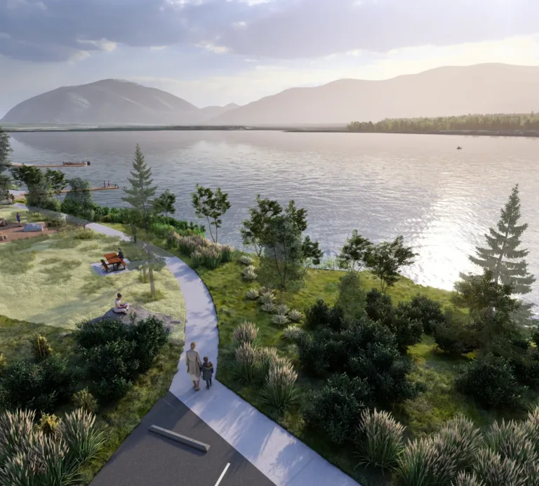Rendering of a riverside park with a curving path, benches, and a small playground among trees, overlooking a calm, mountain-framed river with a few boats in soft afternoon light.