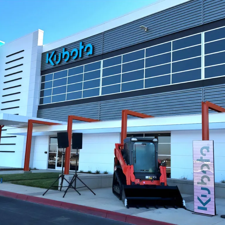 Kubota industrial factory with skid steer parked near entrance