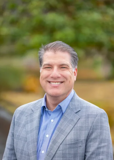 The CFO smiling and wearing suit jacket