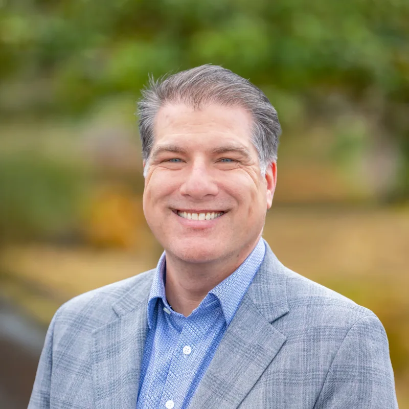 The CFO smiling and wearing suit jacket